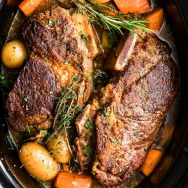 Slow cooker pork roast served with vegetables and gravy