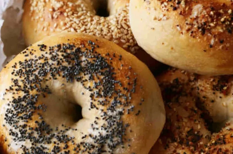 Freshly baked sourdough discard bagels on a cooling rack