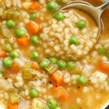Bowl of hearty veggie barley soup with fresh vegetables and barley grains