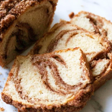 Slice of cozy cinnamon swirl vanilla pound cake on a plate
