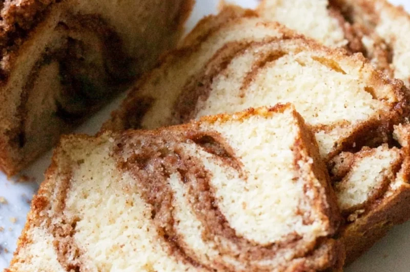 Slice of cozy cinnamon swirl vanilla pound cake on a plate