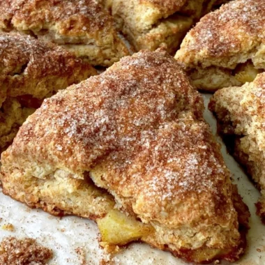 Freshly baked cozy apple scones on a rustic table.