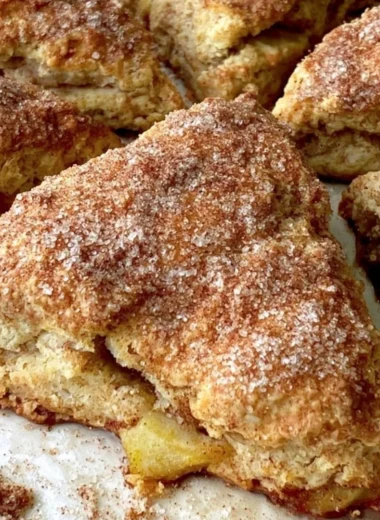 Freshly baked cozy apple scones on a rustic table.