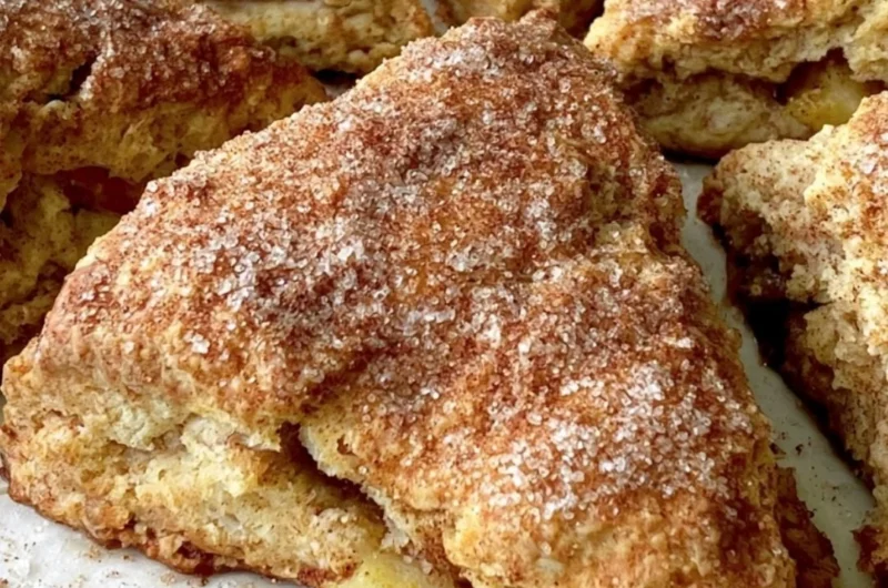 Freshly baked cozy apple scones on a rustic table.