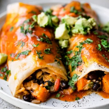 Delicious cozy vegetarian enchiladas topped with cheese and fresh herbs