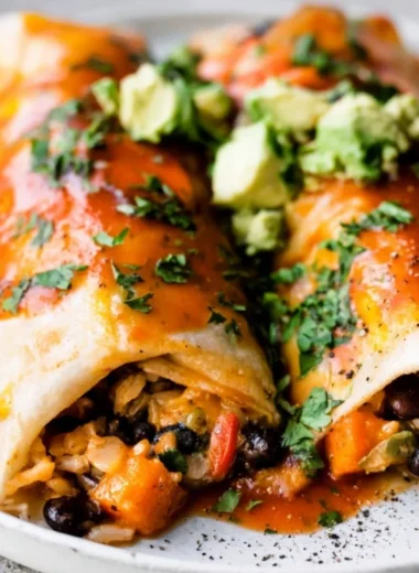 Delicious cozy vegetarian enchiladas topped with cheese and fresh herbs