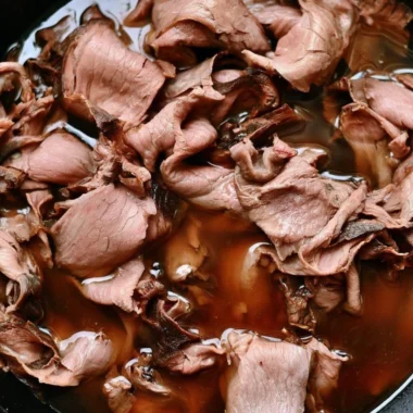 Easy French Dip Sandwich with roast beef and provolone cheese on a plate