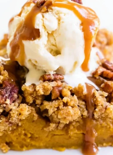 Delicious Pumpkin Pie Crunch Cake topped with a crunchy layer and whipped cream