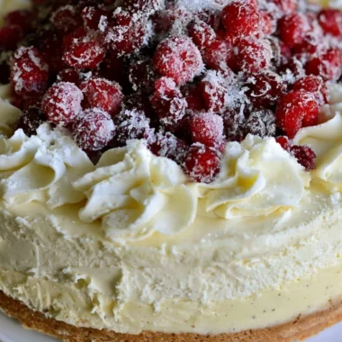 Christmas cheesecake with cranberry jam and white chocolate mousse topping
