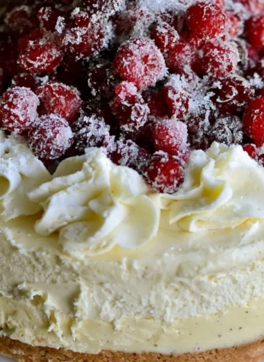 Christmas cheesecake with cranberry jam and white chocolate mousse topping