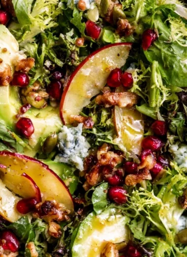 Colorful Christmas Salad topped with honey mustard dressing in a festive bowl.