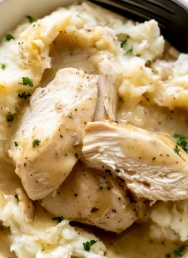 Instant Pot Chicken and Gravy served in a bowl with herbs and spices