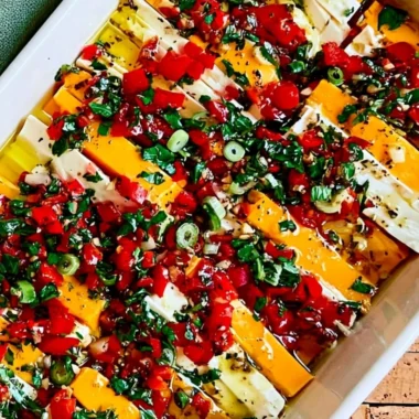 Delicious marinated cheese served as an appetizer with herbs and spices.